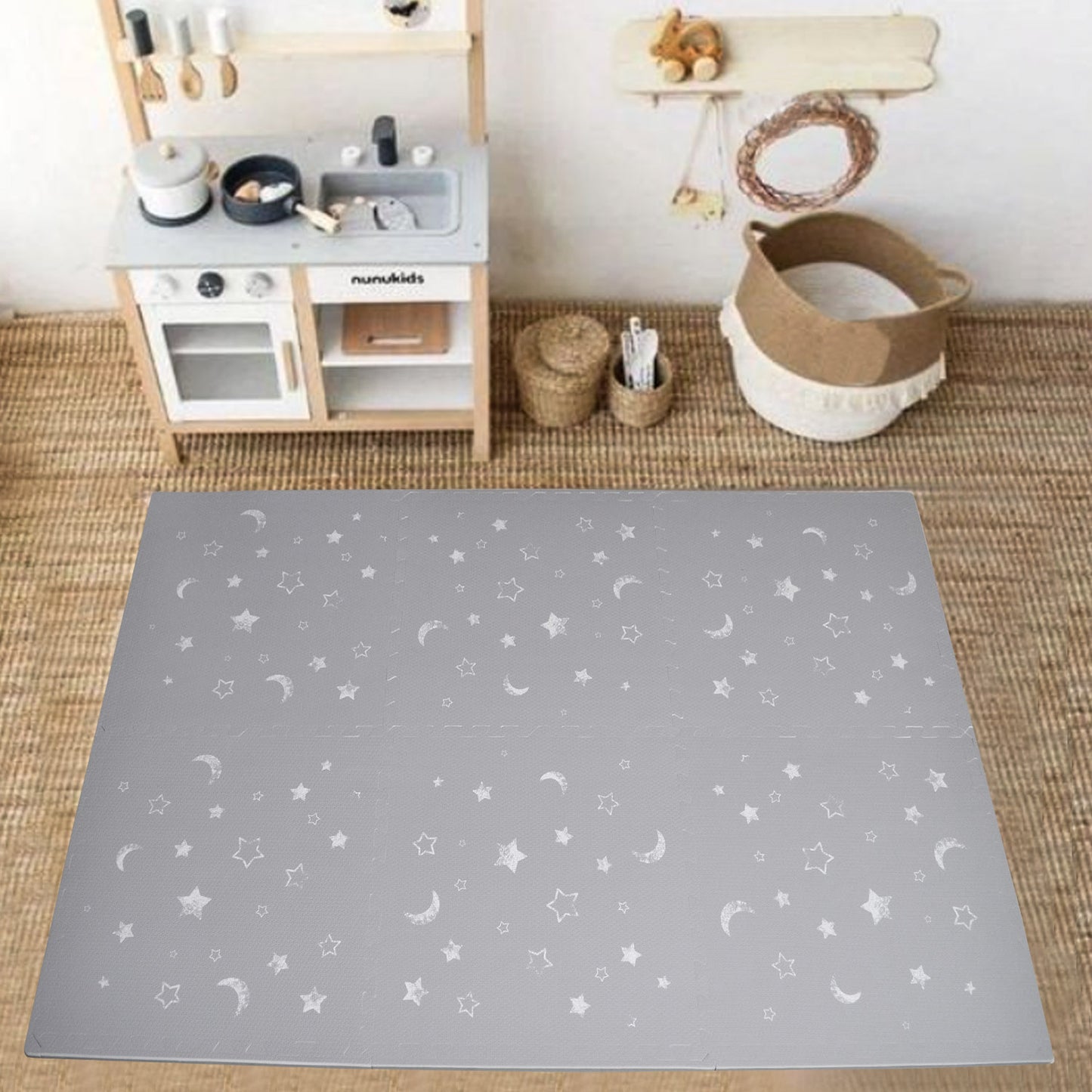 Faded stars and moons on grey play mat